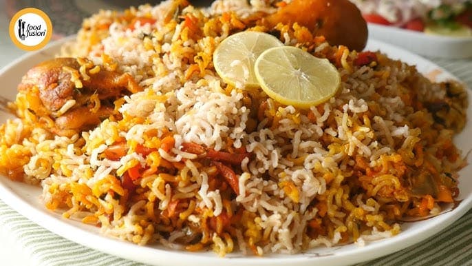 A platter of Brown Rice Chicken Biryani, mixed with vegetables.