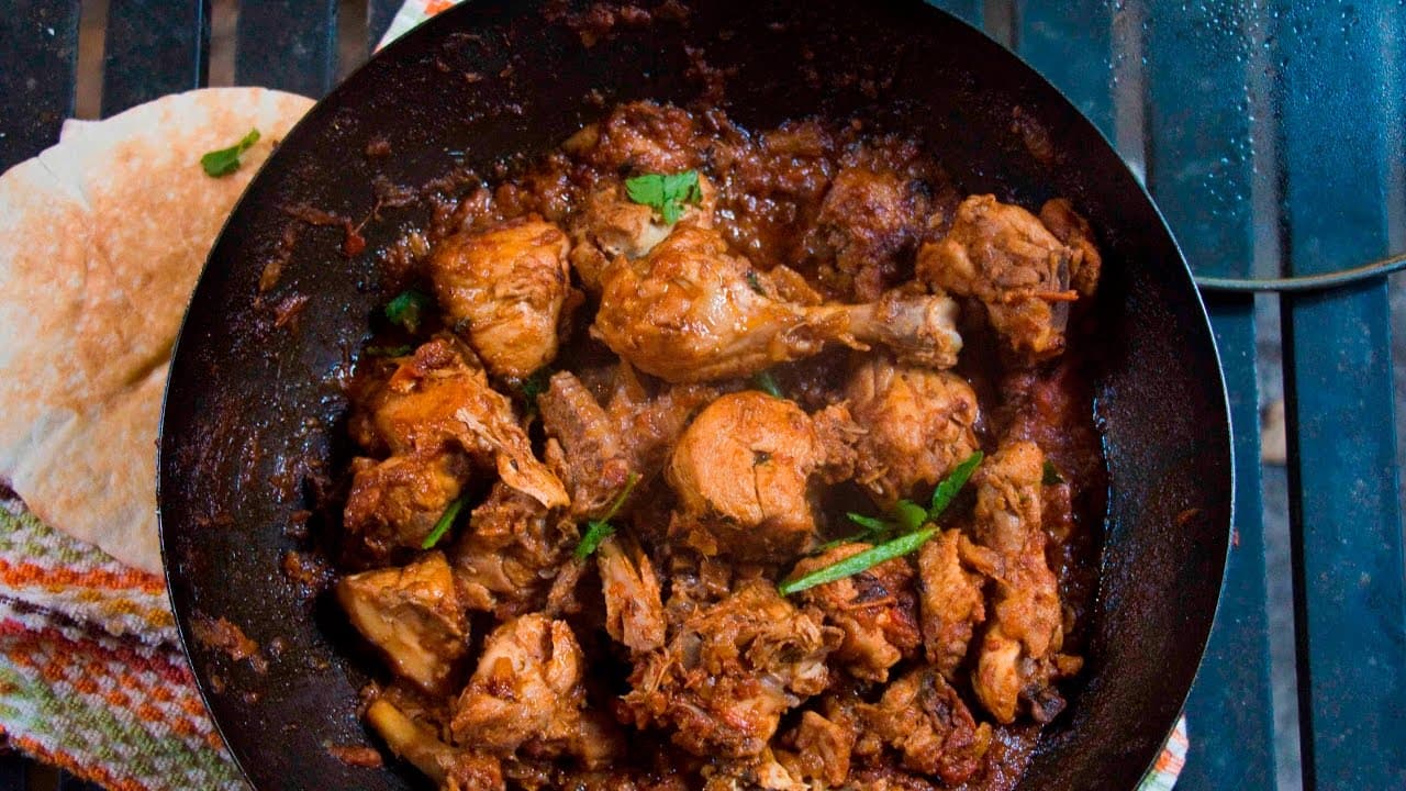 Spicy Chicken Karahi in a traditional wok-like pan.