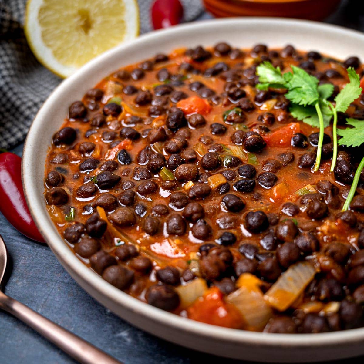 A rustic bowl of Kala Chana Curry, a dark chickpea stew.